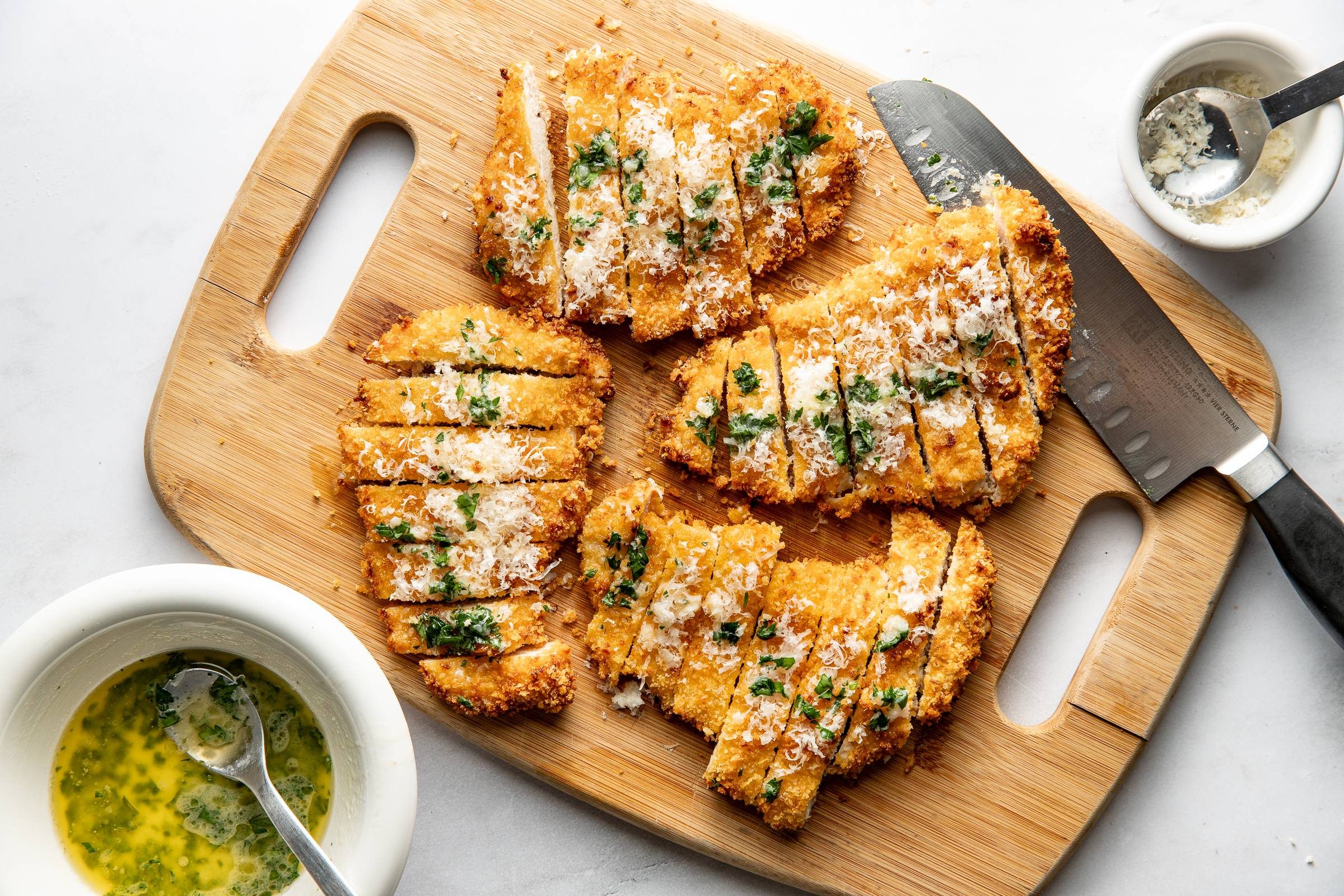 Crispy chicken sliced on a cutting board.