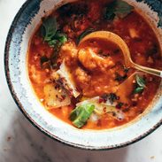 Spoon in a bowl of tomato and bread soup