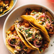 Chicken tacos on a plate with creamy corn