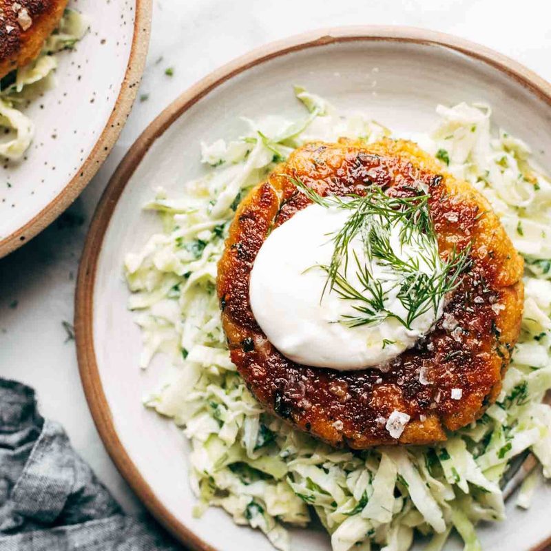 Salmon Burger on a plate with slaw.