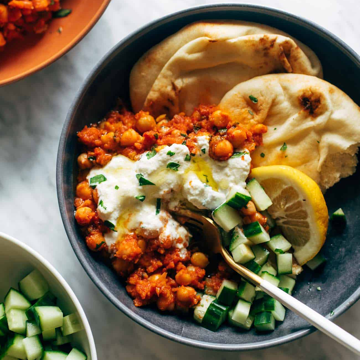 Harissa chickpeas in a bowl with whipped feta.