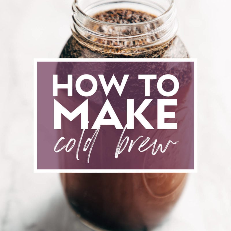 Image of a mason jar filled with coffee grounds and water steeping to make cold brew. There's text over the jar that says "How to Make Cold Brew"
