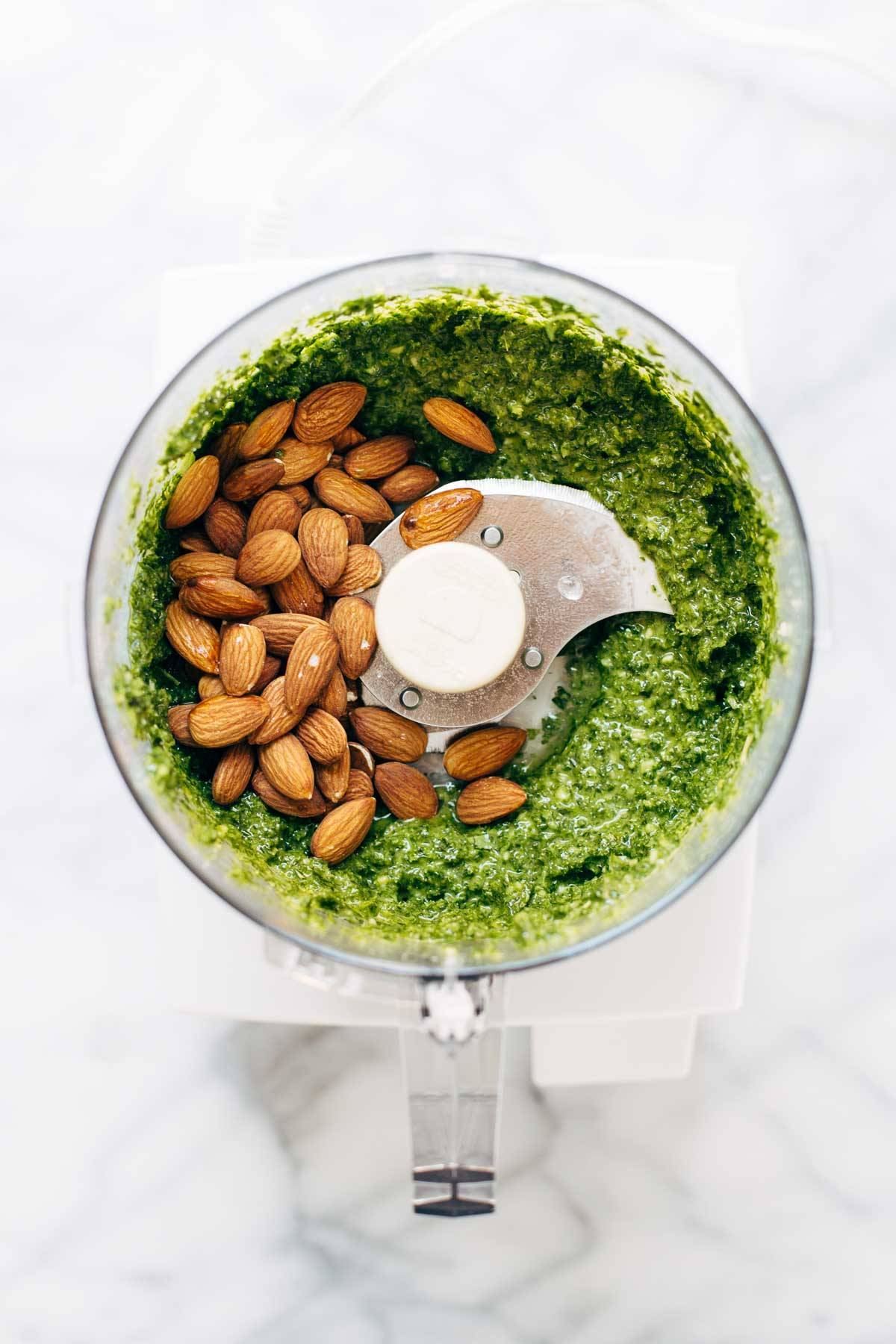 5 Minute Vegan Kale Pesto - made with almonds, olive oil, kale, garlic, salt, and lemon juice. Less than 150 calories per serving! | pinchofyum.com