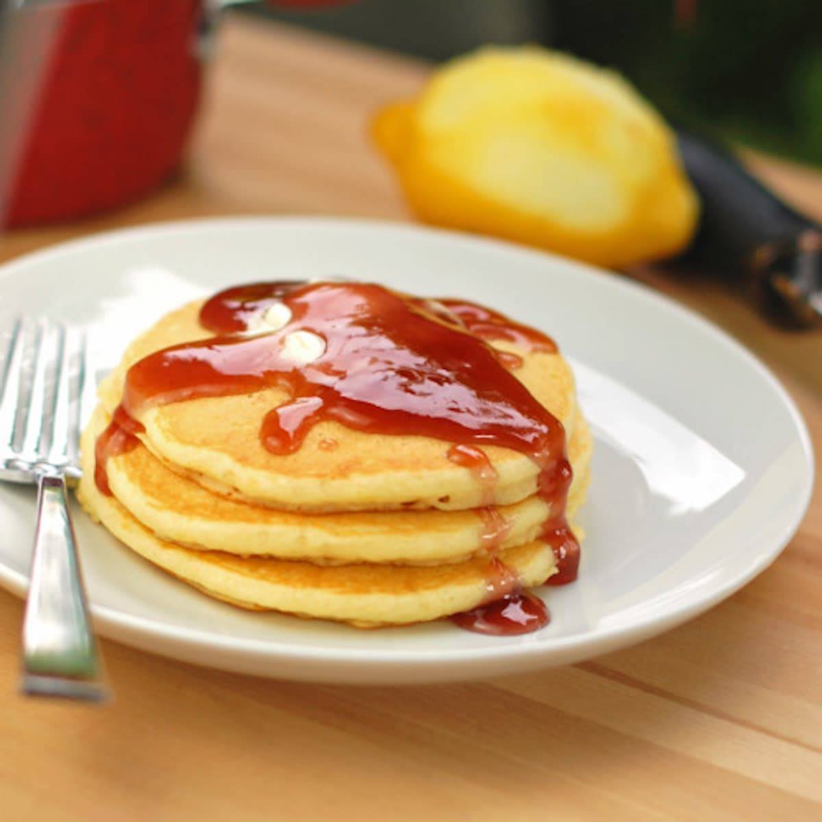 Lemon Pancakes topped with a blackberry syrup made from blackberry jam.