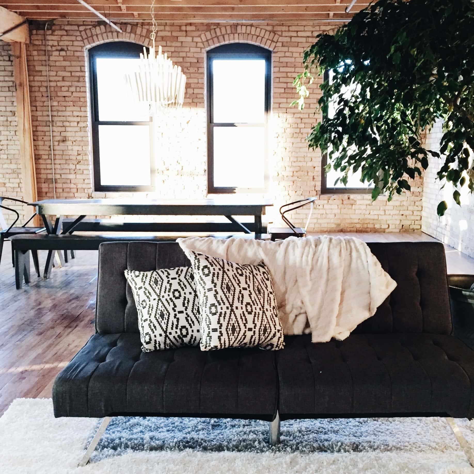 couch with throw pillows and a blanket